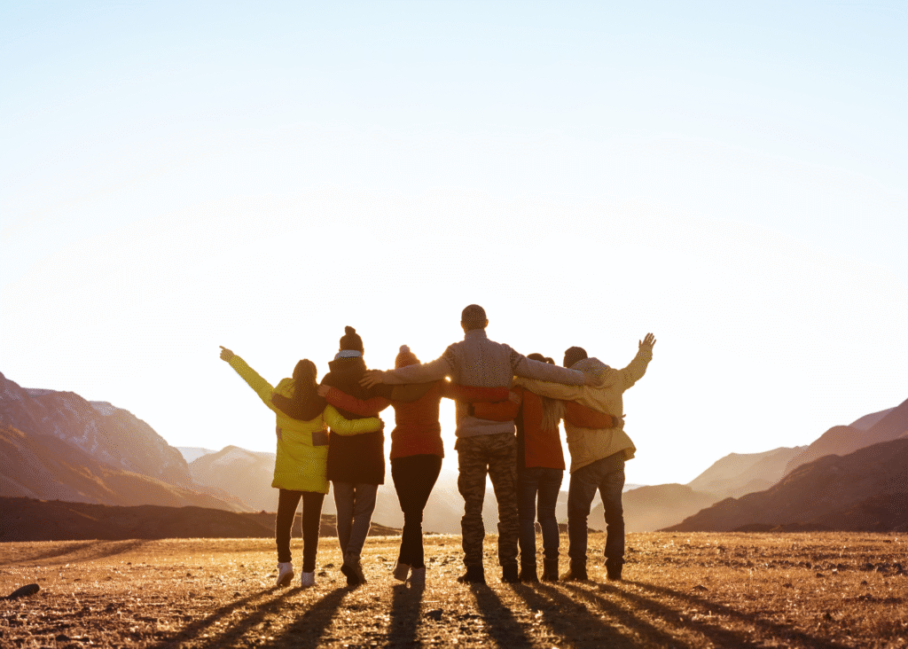 group of people in the mountains with the sunlight casting shadows of them